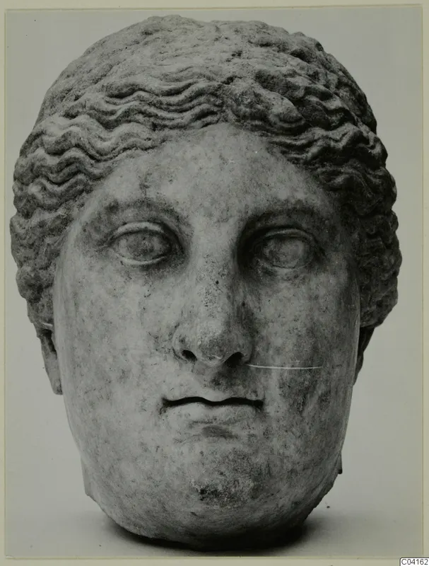 Marble head with wavy hair, shown front-on against a plain grey background