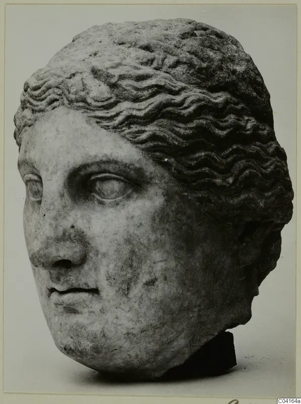 Marble head of a figure with wavy hair, shown in a mounted photograph