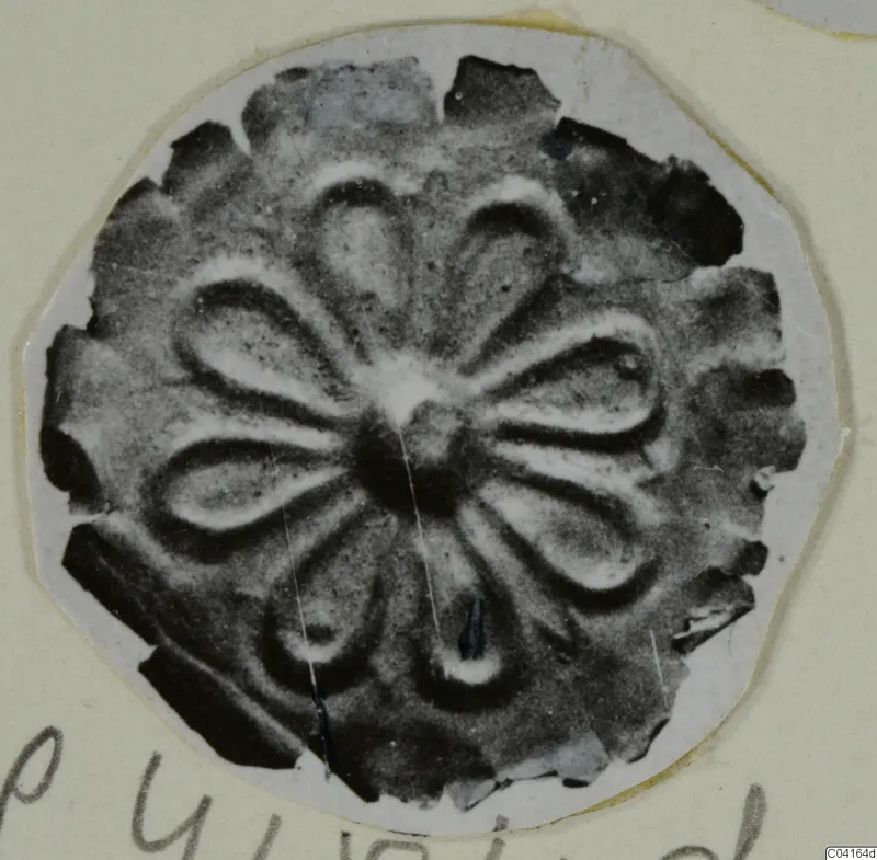 Disc-shaped gold ornament with petal-shaped lobes around a central boss, from Arsos