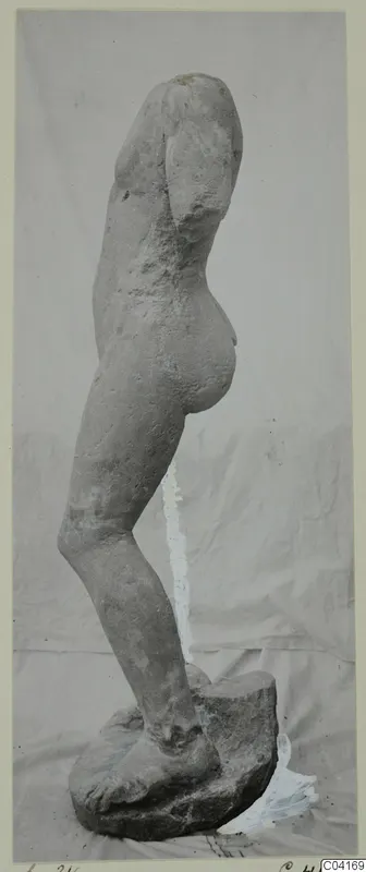 Stone statue of a standing figure in side view, with head and arms missing, from Soli