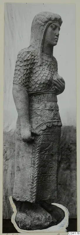 Stone statue of a standing figure from Soli, with scale-patterned upper garment, wide belt and carved skirt panels