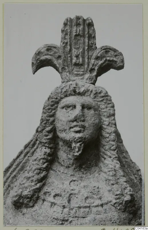 Stone statue of a head and upper body from Soli, with long wavy hair and a tall headdress with crescent-shaped side elements