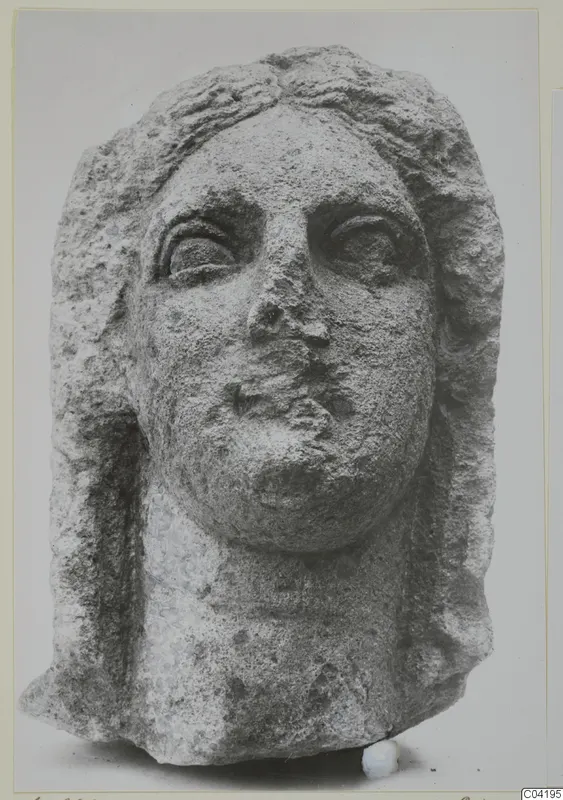 Stone statue head from Soli, face and hair in limestone with worn surface