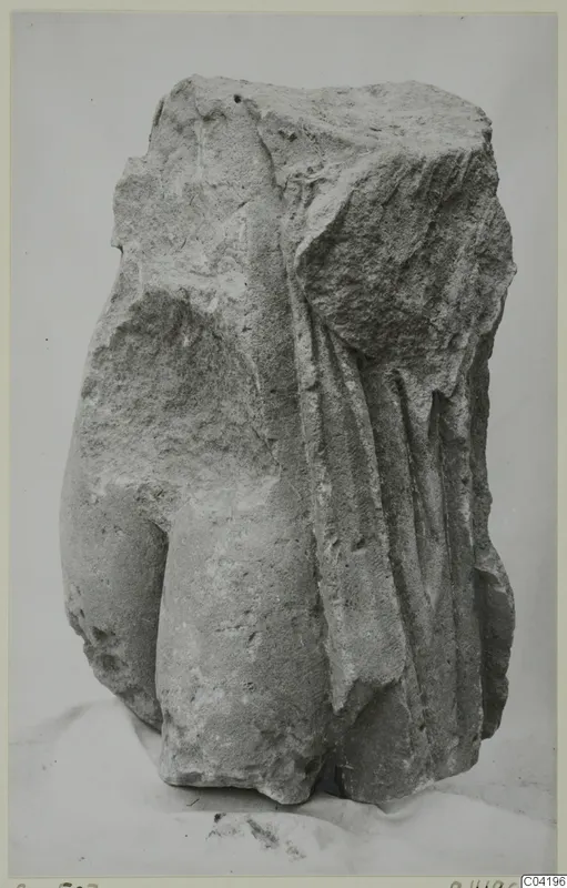 Stone sculpture fragment from Soli, a draped figure's torso with broken upper part.