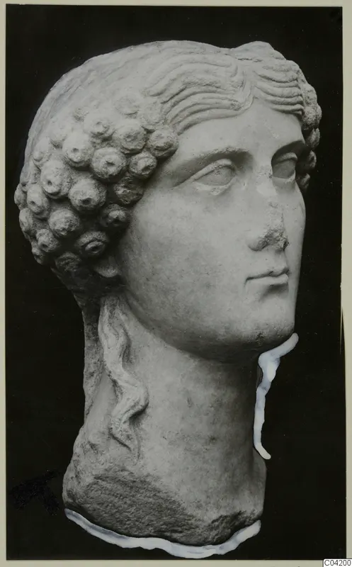 Carved marble head with rows of curled hair at the back and wavy locks across the brow