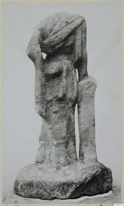Marble sculpture of a standing figure with its head covered by drapery, one arm raised to the head, beside an upright support