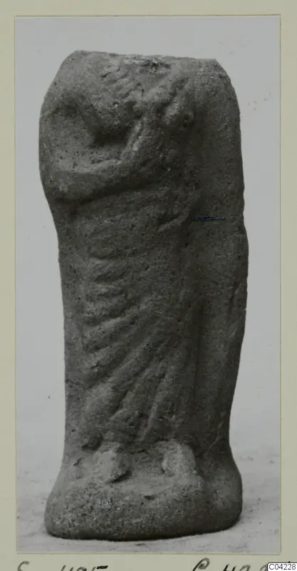 Terracotta figurine of a standing draped figure, head and upper body broken away, one arm bent across the body.