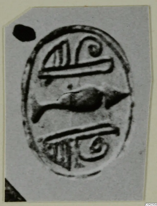 Oval seal face with spiral and linear motifs around a dark central motif