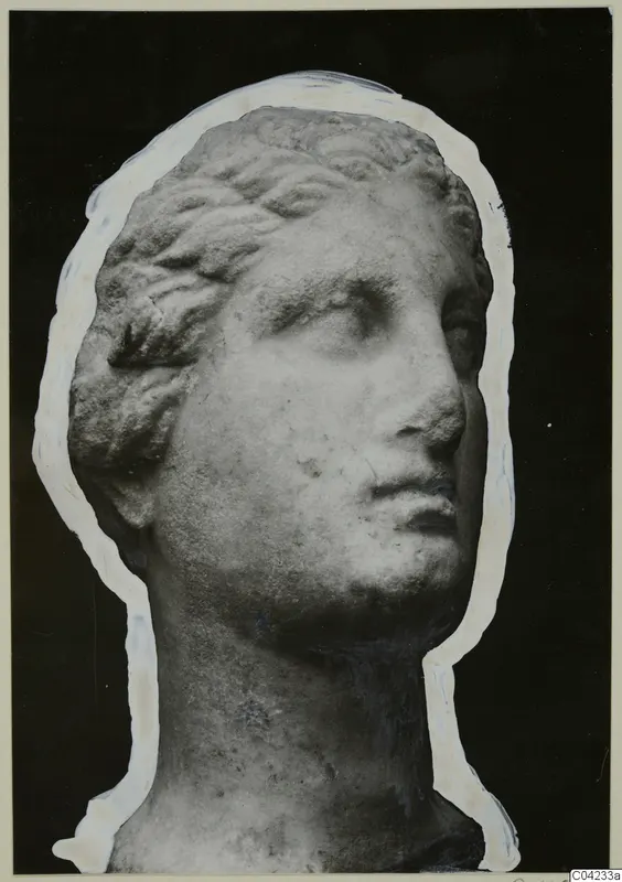 Carved marble female head with wavy hair, turned to the right, shown against a black background