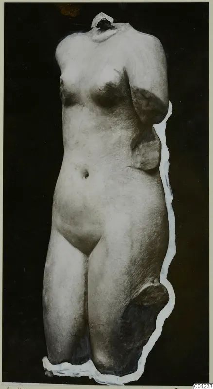 Marble sculpture of a headless female torso, shown against a dark background