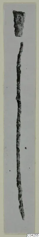 Bronze tools from Milia: a long, thin corroded rod and a short fragment, shown on a grey mount