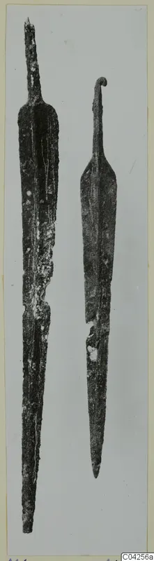Two metal blades, one with a curled hook at the top; find from Milia