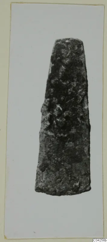 Corroded metal blade with a tapering form, from Milia, shown alone against a pale background.