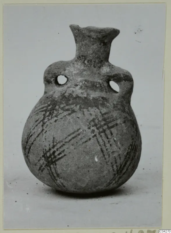 Round-bodied jug with two pierced lug handles and crossed dark painted bands on the lower body