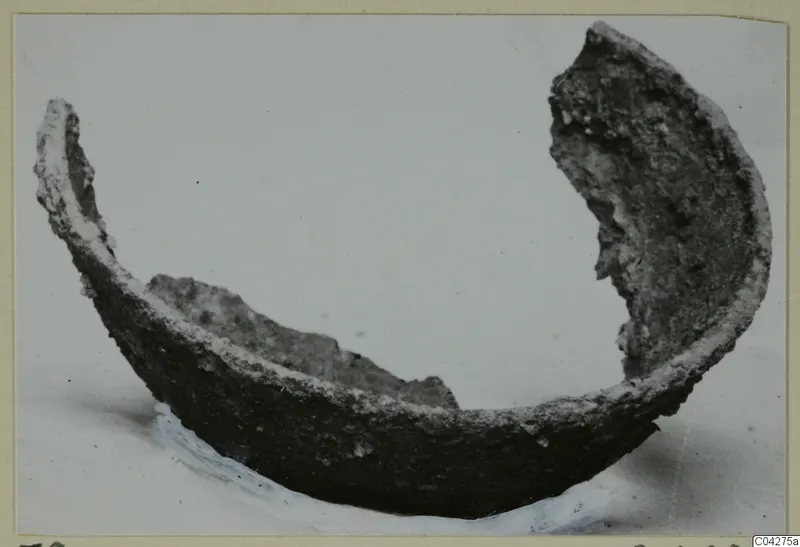 Fragment of a bowl from Amathus, dark and encrusted, with broken rims