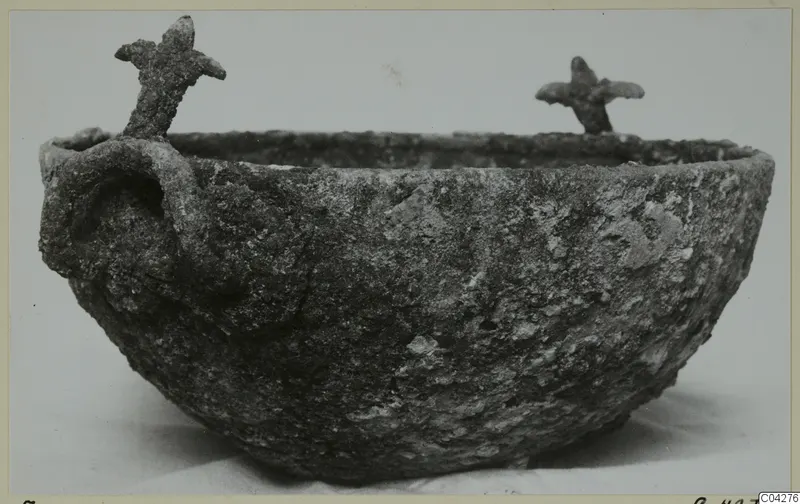 Corroded bowl from Amathus with a loop handle on one side and two small upright projections on the rim.