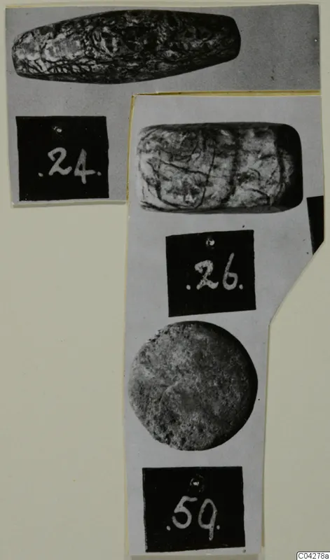 Three stone objects from Amathus shown on a mounted card, each with a number label beneath it