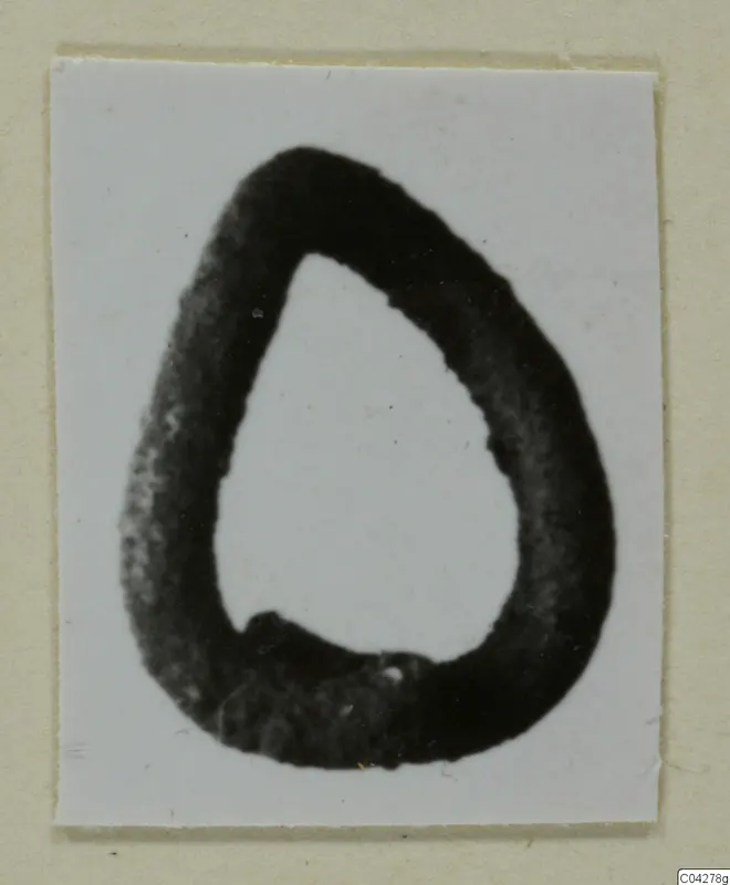Teardrop-shaped loop find from Amathus, shown dark against a white background