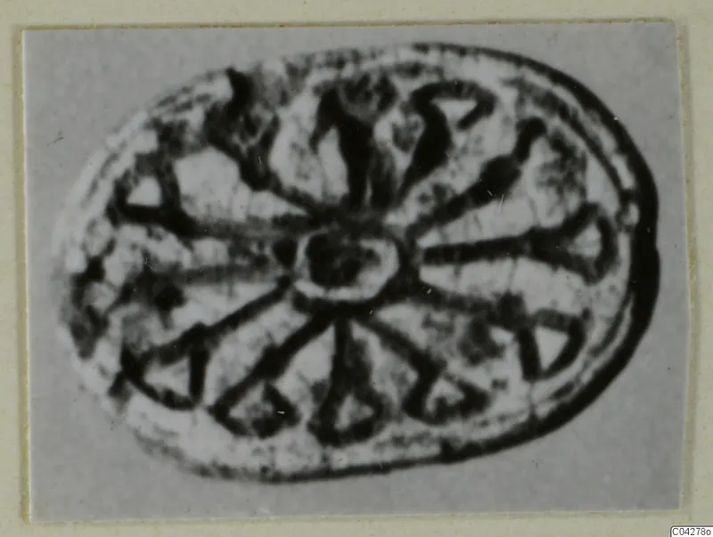 Oval seal or gem from Amathus with a central boss and dark radiating lines around it