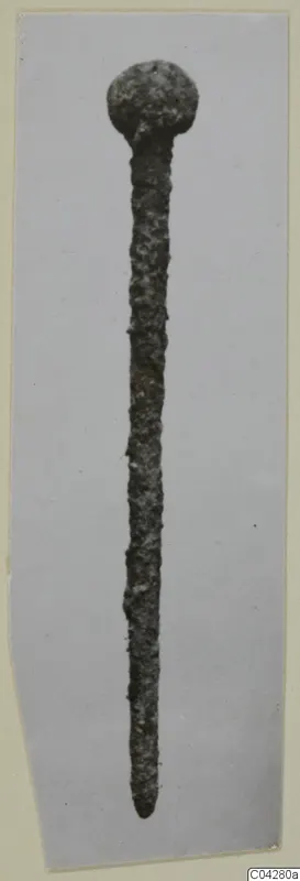 Corroded metal pin with a rounded head, from Amathus, shown on a grey card mount.