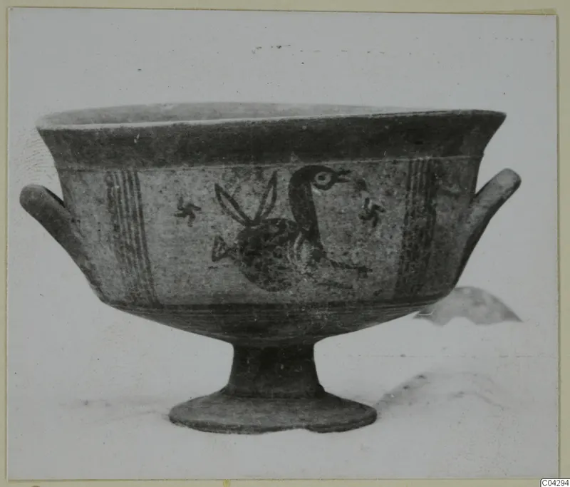 Painted pottery bowl on a tall foot, with a large bird and small cross-like motifs on its side