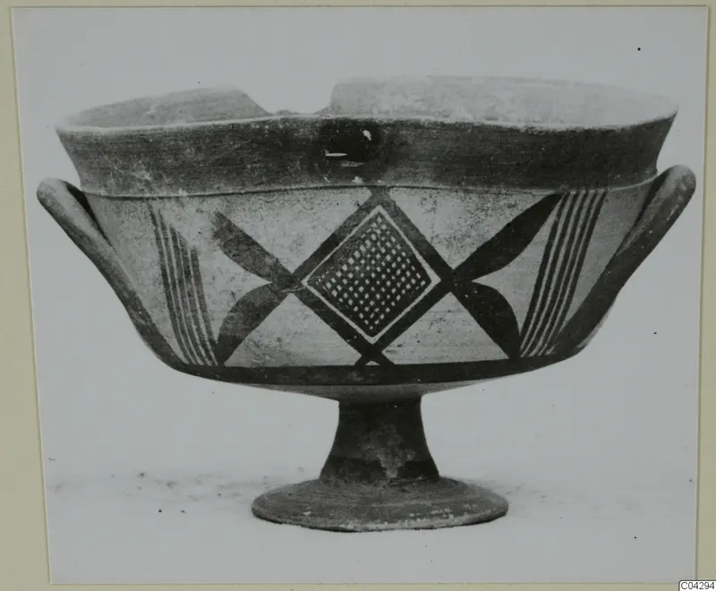 Footed pottery bowl with side handles, painted with dark bands, a diamond lattice panel and crossed motifs
