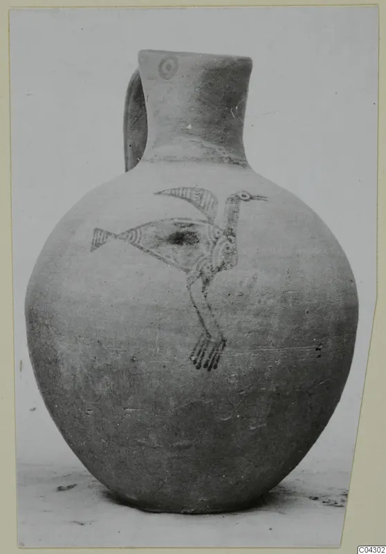 Round-bodied jug with a handle and a painted bird design on its body
