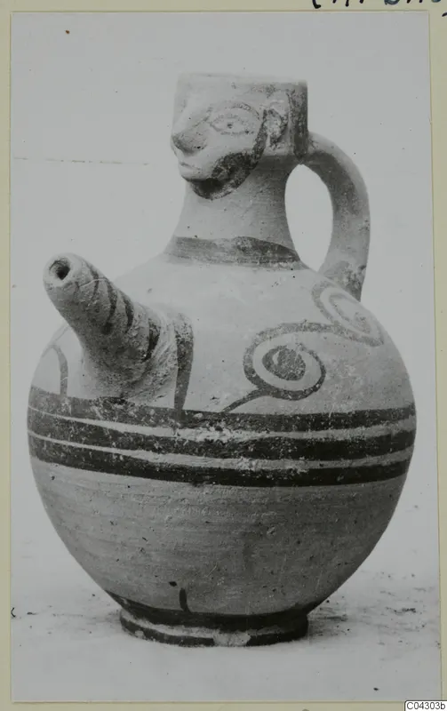 White Painted IV pottery jug with a modelled face at the neck, a side spout, and painted bands and spirals