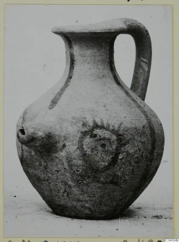 Pottery White Painted IV: a jug with a single loop handle, a short nozzle on the shoulder and a round applied motif on the body