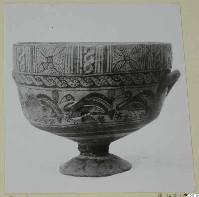 Painted pottery bowl on a ring foot with a single handle, decorated with bands of pattern and bird-like motifs