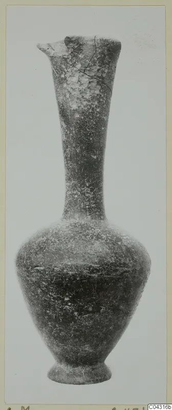 Pottery vessel with a tall narrow neck, a flared rim with a pinched spout, and a ring foot