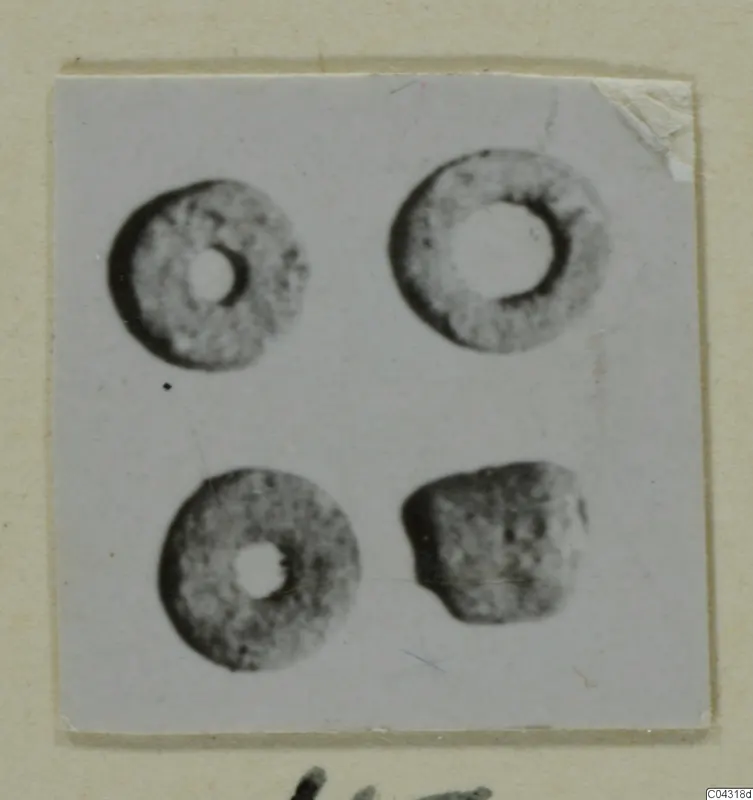Four small ring-shaped objects from Amathus, photographed and mounted on a card.