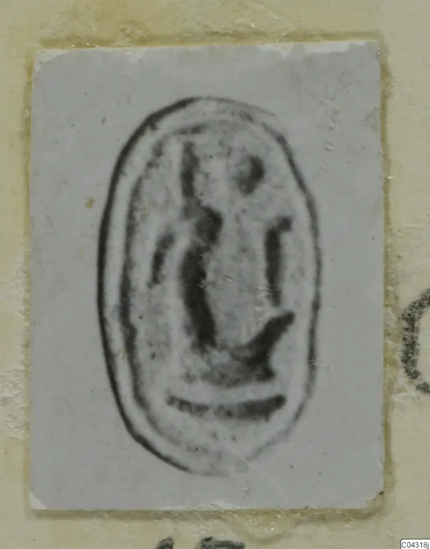 Oval seal impression on a small pale card, dark marks inside a raised border, from Amathus