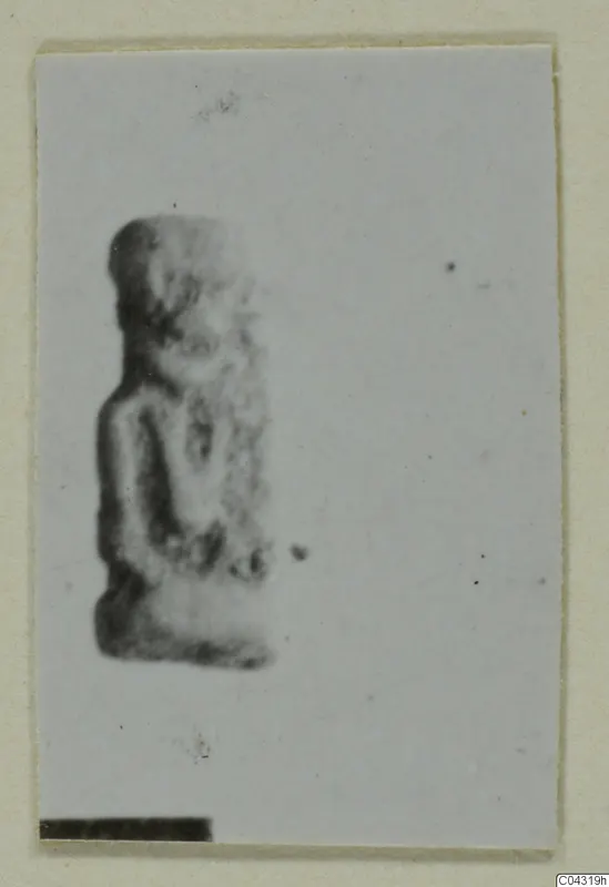 Small blurred figure of a standing human form, shown on a pale mount