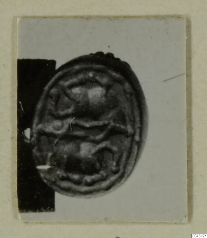 Oval seal with a raised design, from Amathus tomb group 2-26, photographed on a card mount