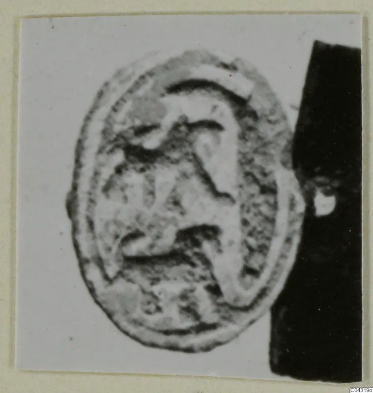 Oval engraved seal from Amathus, shown as a close-up photograph on a pale card background