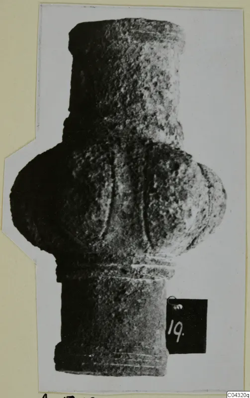 Bronze tool from Amathus: a grooved, cylindrical object with a bulbous middle, photographed upright