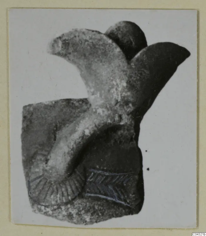 Faience fragment from Amathus: a curved raised element on a block-shaped base, with incised and blue-drawn marks.