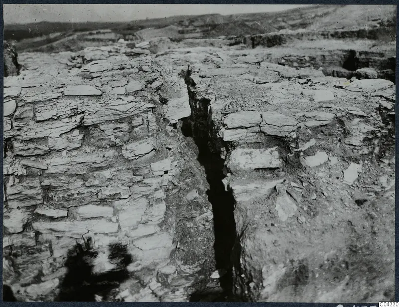 Excavation on the Idalion Acropolis with a narrow cut between layered rock faces