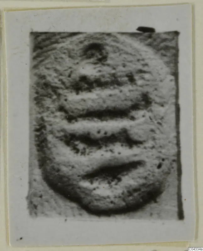 Glyptic find: a rounded stone object with horizontal bands, shown close up