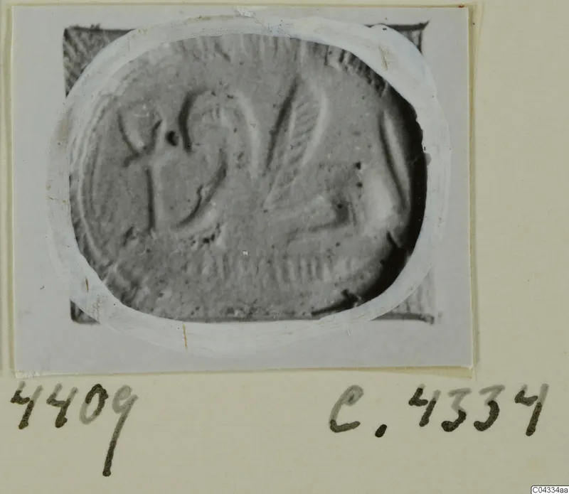 Engraved oval seal or gem from Ayia Irini, shown in a photograph on a card mount