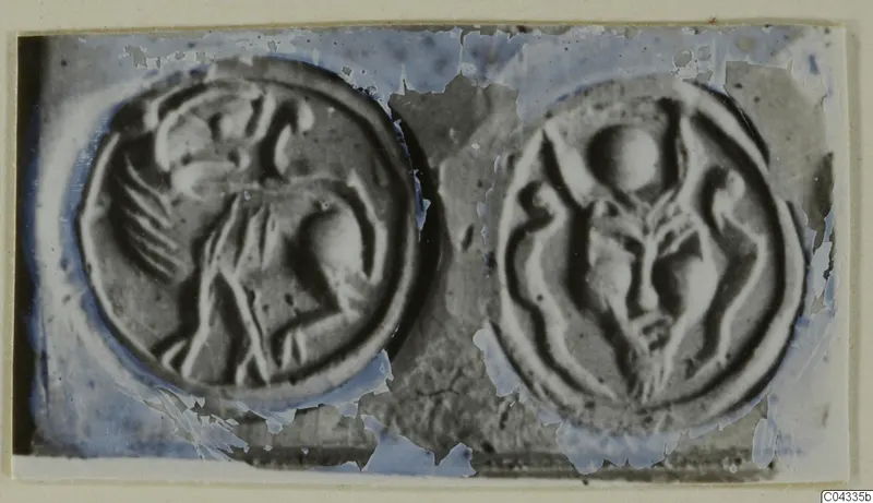 Two round engraved seal faces shown side by side, each with a raised figure design.
