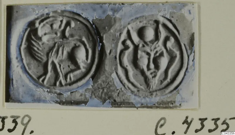 Two round seals with raised carved designs, shown side by side on a card mount