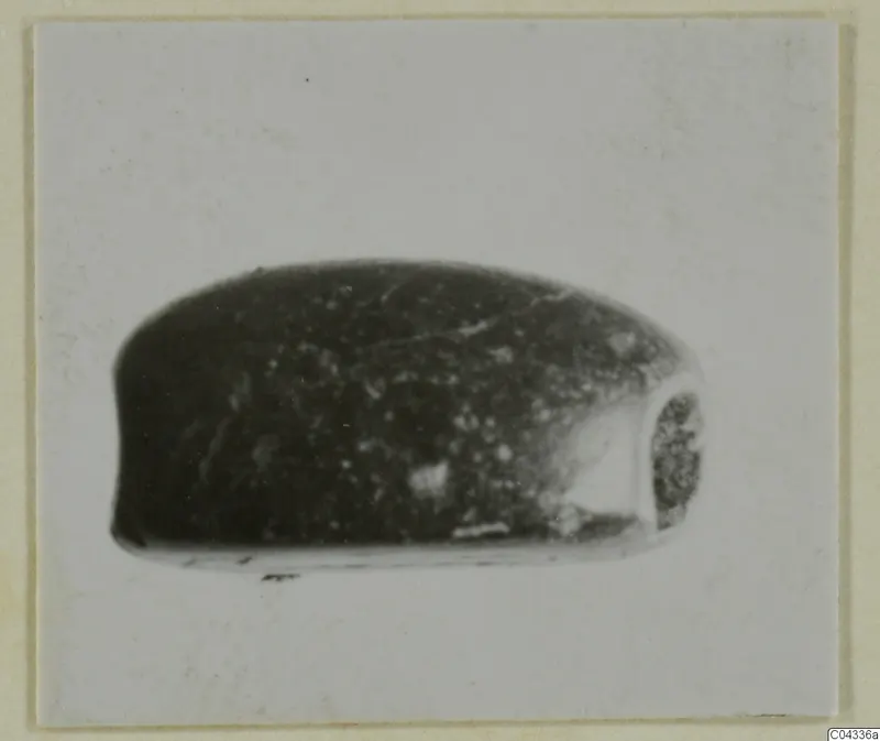 Dark stone glyptic object, rounded and elongated, from Ayia Irini