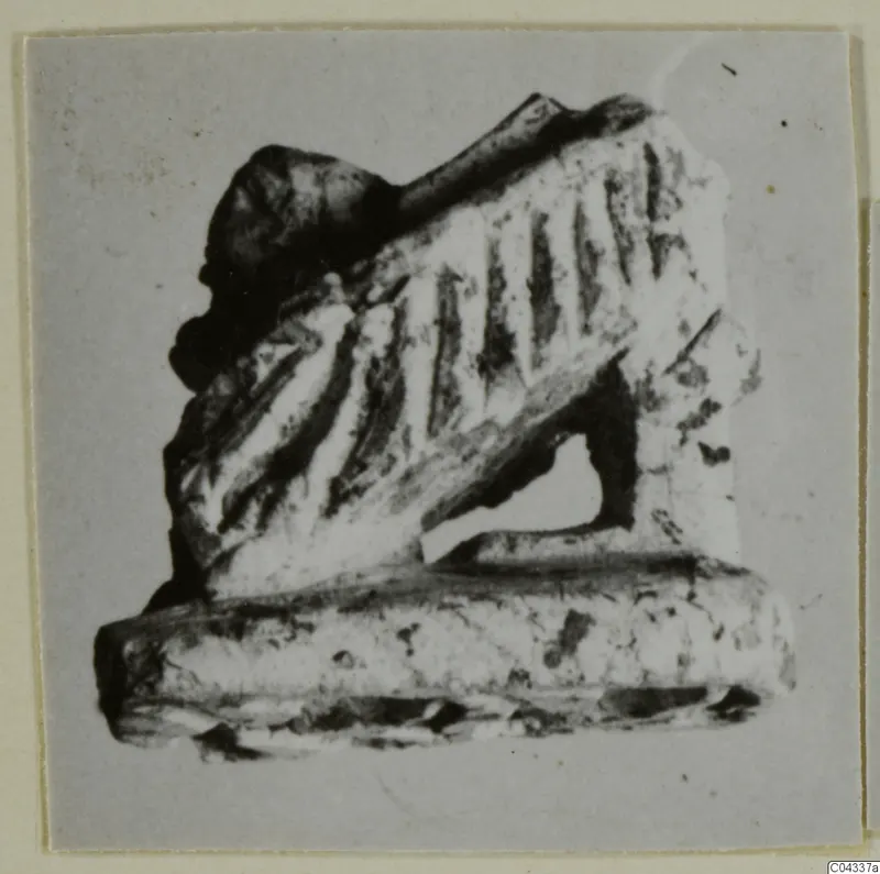 Small carved stone object with grooved sloping surface and flat base, Ayia Irini find