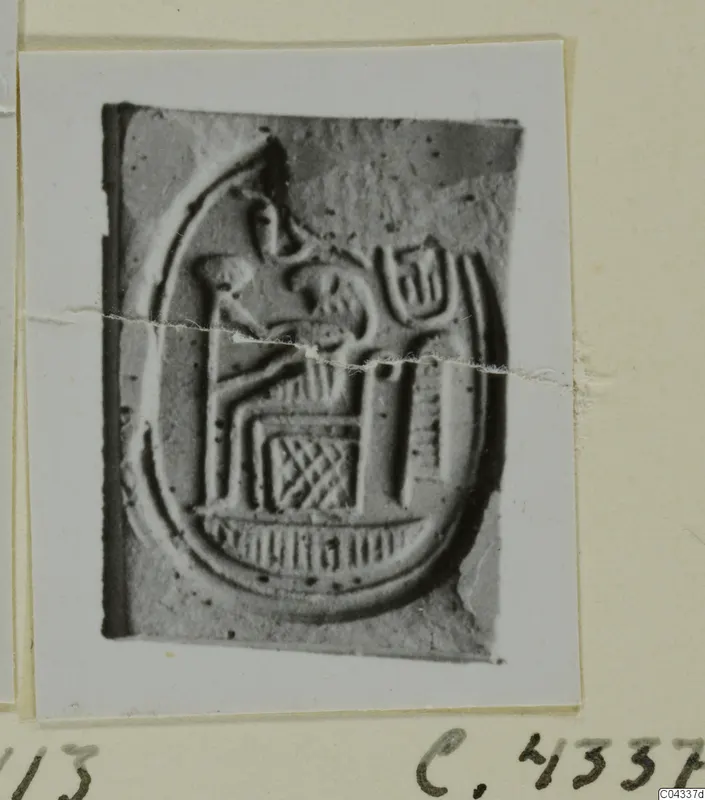 Stone seal from Ayia Irini with a seated figure and lattice pattern inside an oval border