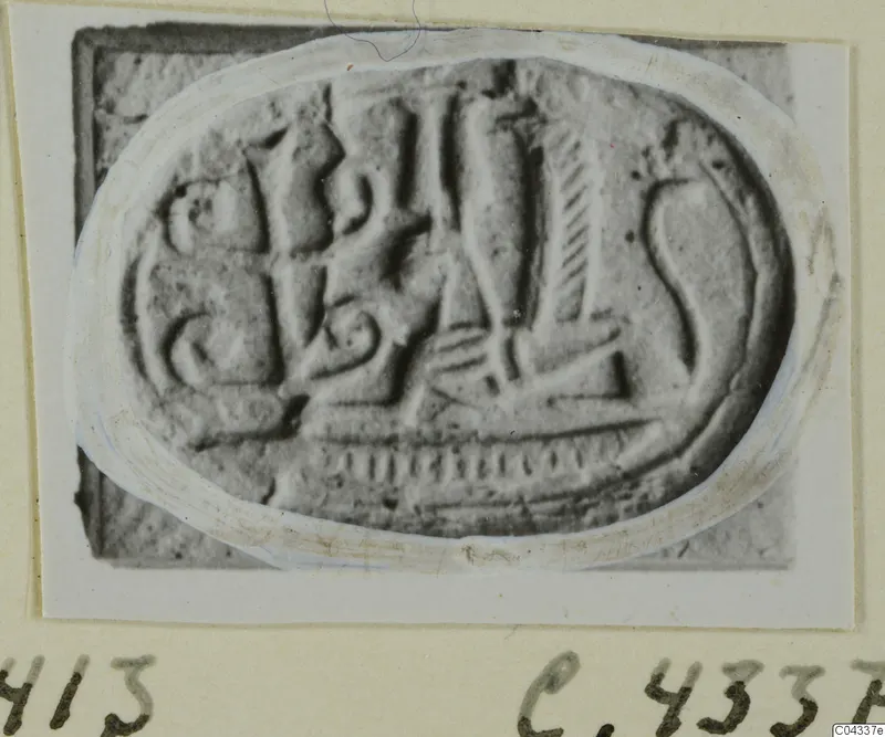Engraved oval seal or gem with raised figures and lines, photographed on a mounted card