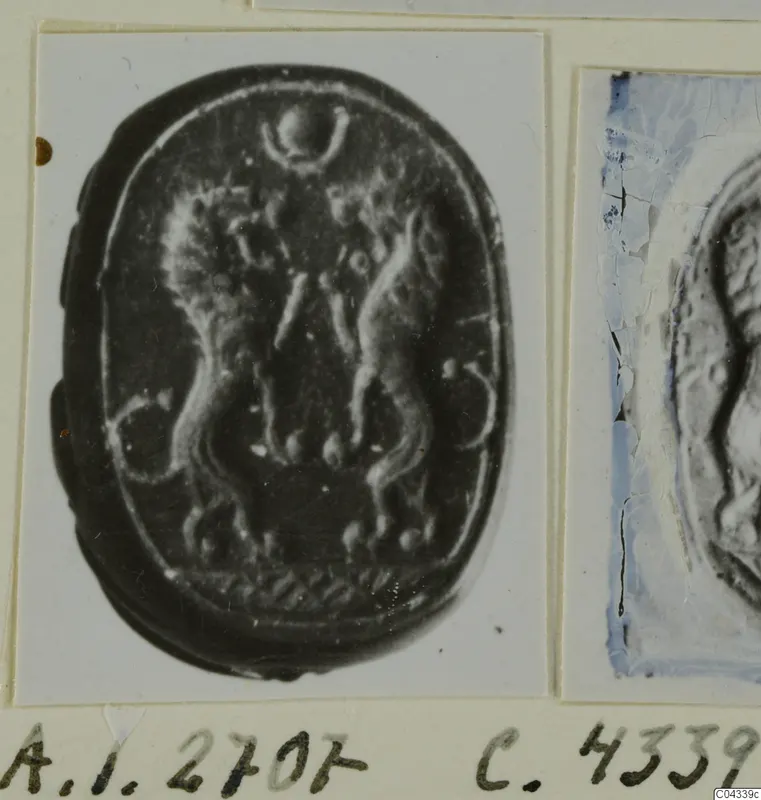 Enlarged photograph of an oval seal with carved figures, mounted on an album card