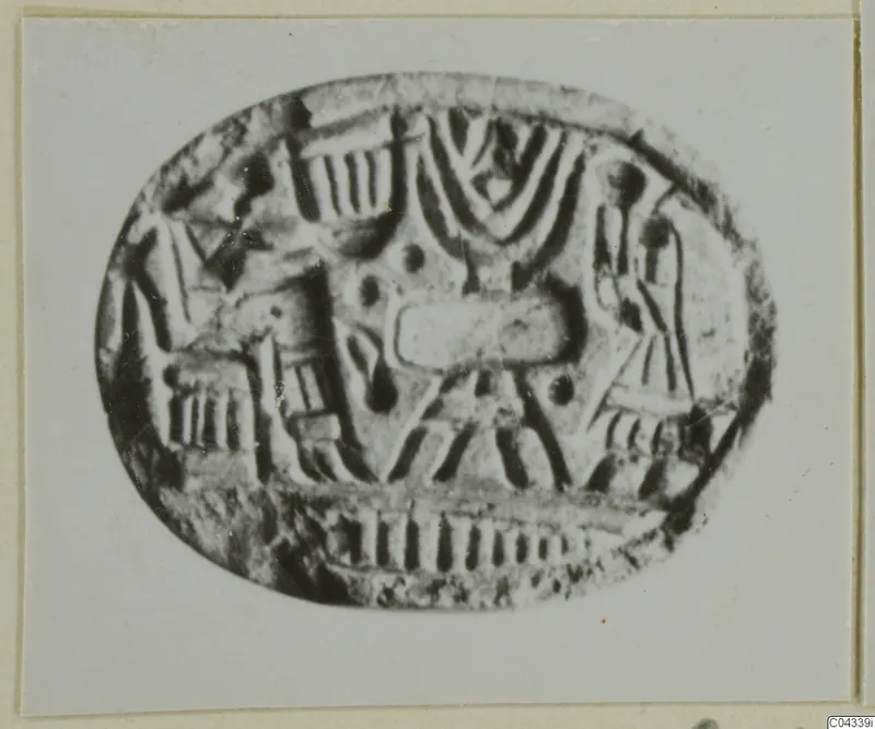 Oval engraved seal or gem with linear and dotted motifs, photographed enlarged on a card mount