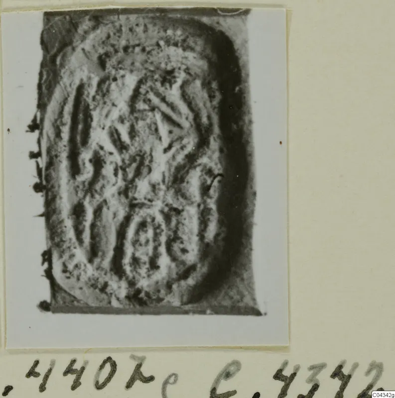 Engraved seal or gem from Ayia Irini, with incised curved and angular design, shown on an album card